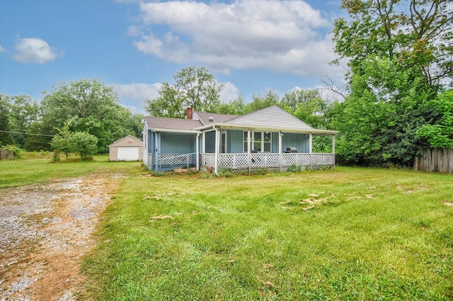 view of front of house with a garage, an outdoor structure, a porch, and a front lawn