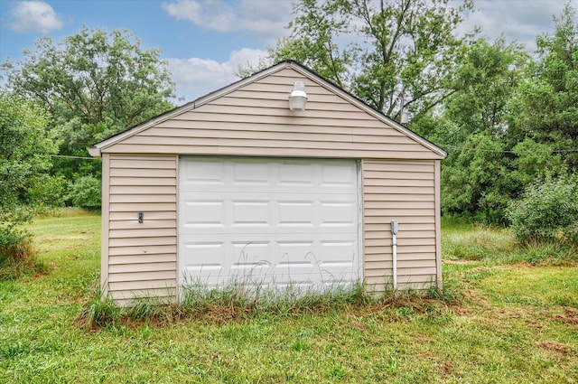 garage featuring a lawn