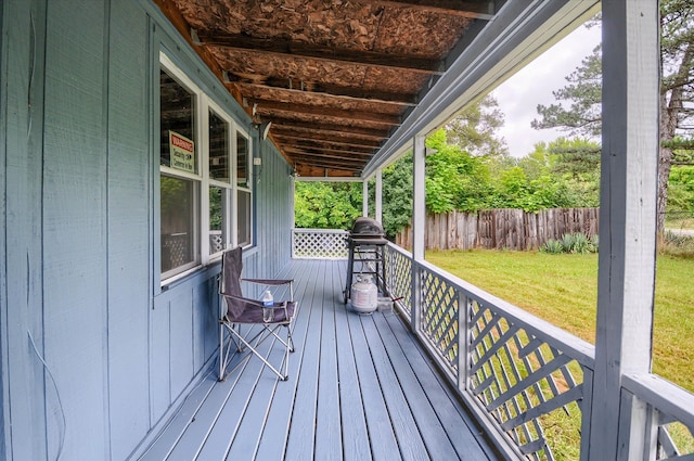 wooden terrace featuring a yard