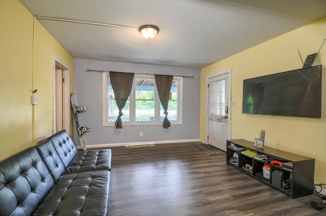 living room with dark hardwood / wood-style flooring