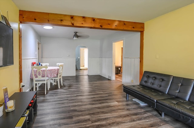 living room with beamed ceiling and dark hardwood / wood-style flooring