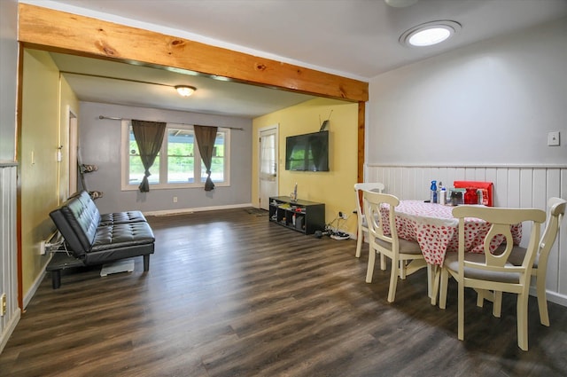 dining space with dark hardwood / wood-style flooring and beam ceiling