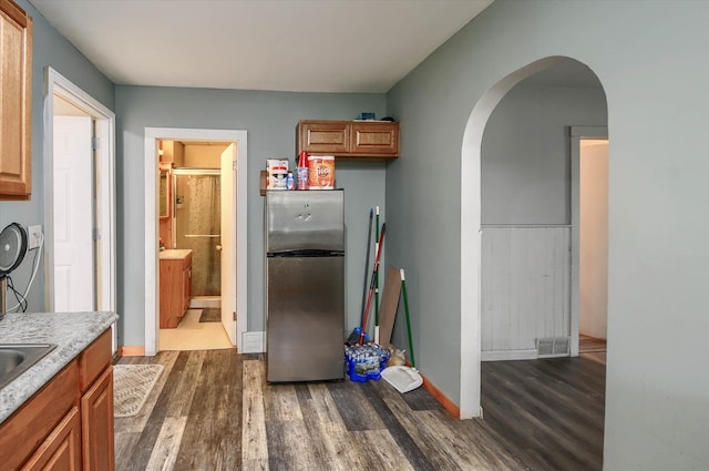 kitchen featuring dark hardwood / wood-style floors and stainless steel fridge