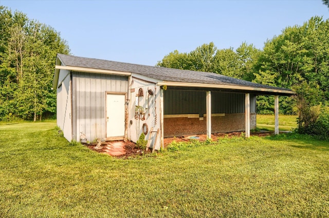 view of outbuilding featuring a yard