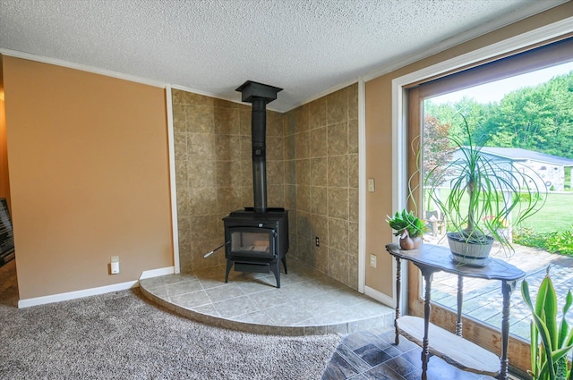 unfurnished living room with a textured ceiling, a wood stove, crown molding, and tile walls