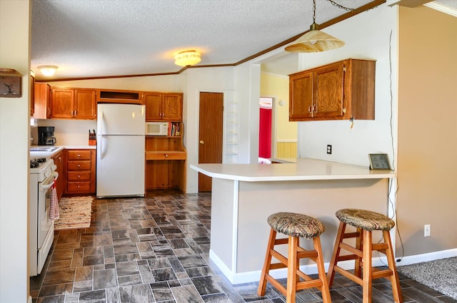 kitchen featuring a breakfast bar, lofted ceiling, white appliances, a textured ceiling, and kitchen peninsula