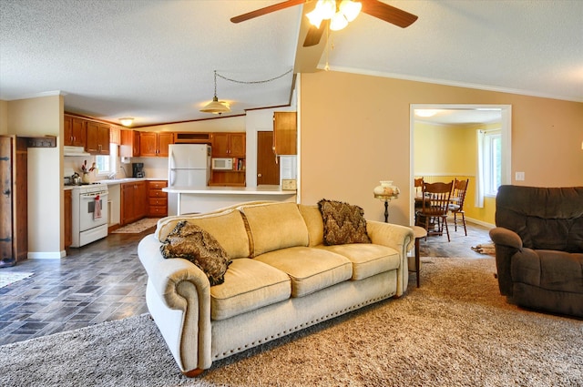 living room featuring a textured ceiling, ceiling fan, lofted ceiling, and ornamental molding