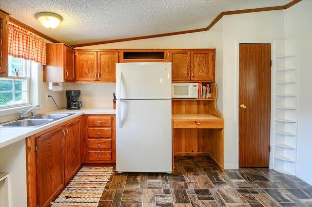 kitchen with lofted ceiling, white appliances, crown molding, sink, and a textured ceiling