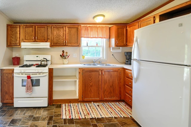 kitchen featuring a textured ceiling, sink, and white appliances