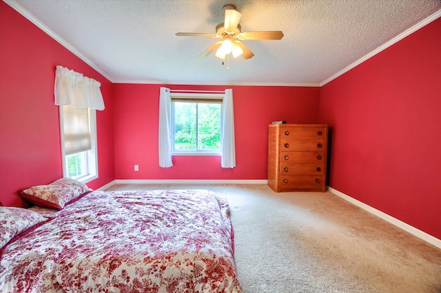 bedroom with ceiling fan, crown molding, carpet, and a textured ceiling