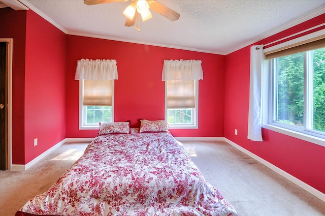 carpeted bedroom with a textured ceiling, multiple windows, and ceiling fan