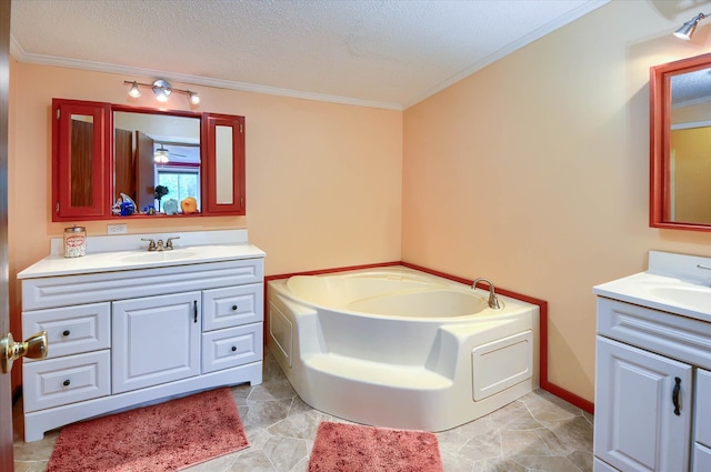 bathroom with a washtub, vanity, a textured ceiling, and crown molding