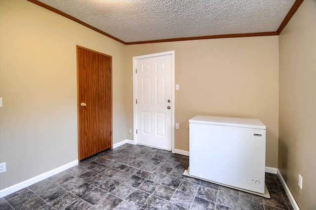 clothes washing area with a textured ceiling and crown molding