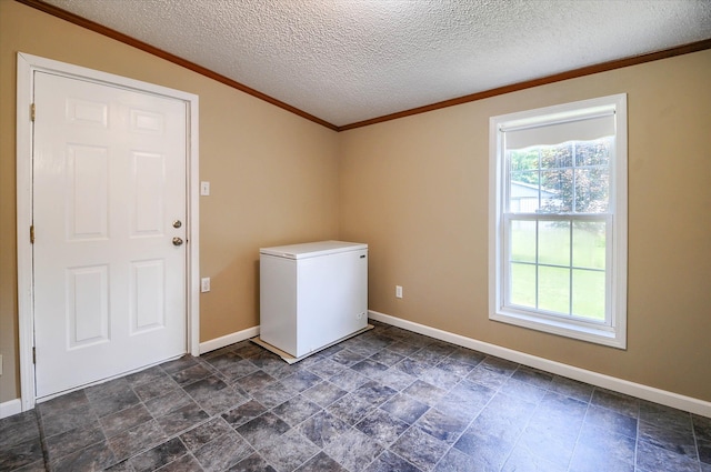 laundry room featuring a textured ceiling and ornamental molding