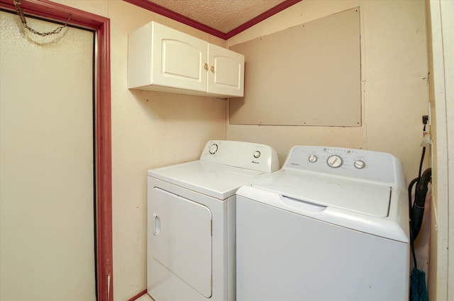 laundry room with cabinets, a textured ceiling, washing machine and dryer, and crown molding