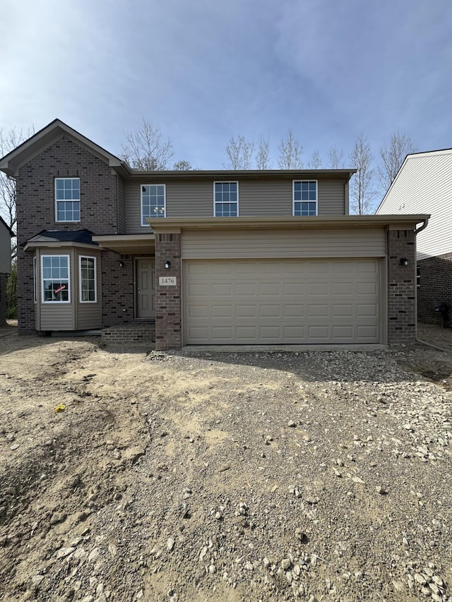 1476 Weeping Willow Ct, Ypsilanti, MI 48198 - traditional-style house with driveway, brick siding, and an attached garage