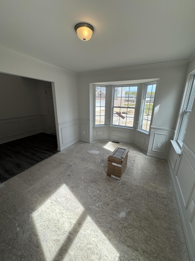 1476 Weeping Willow Ct, Ypsilanti, MI 48198 - spare room featuring a decorative wall, ornamental molding, healthy amount of natural light, and wainscoting