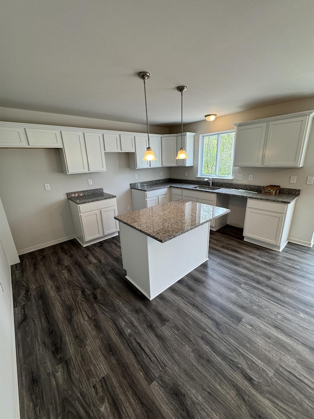 1476 Weeping Willow Ct, Ypsilanti, MI 48198 - kitchen featuring a sink, a center island, white cabinets, decorative light fixtures, and dark wood finished floors