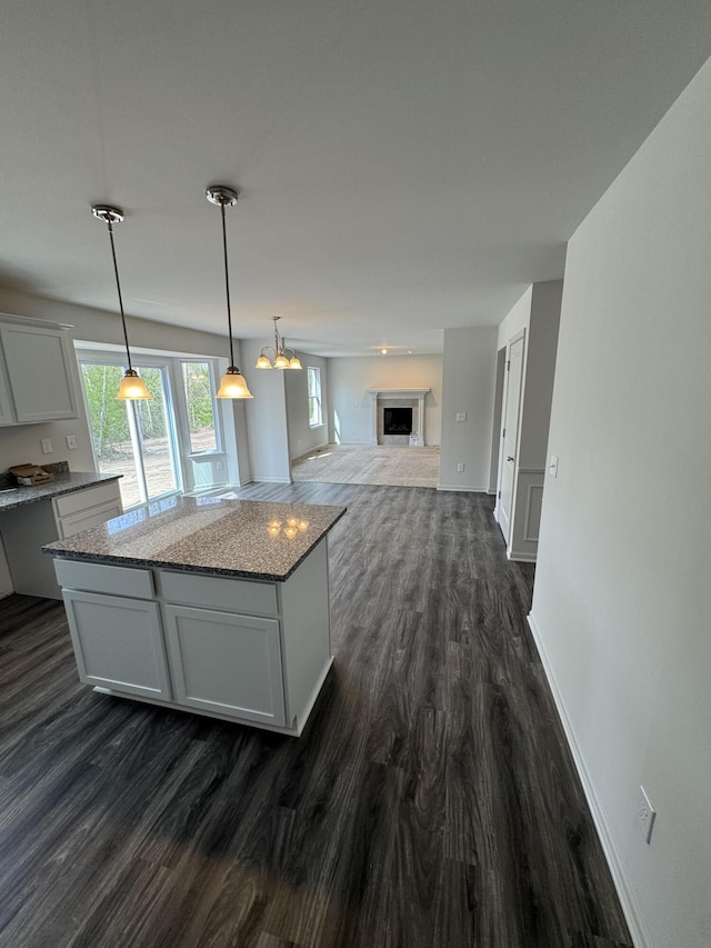 1476 Weeping Willow Ct, Ypsilanti, MI 48198 - kitchen with dark wood finished floors, a center island, and healthy amount of natural light