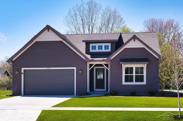 view of front of home featuring a garage and a front lawn