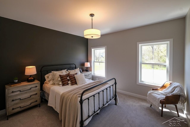 bedroom with multiple windows and dark colored carpet