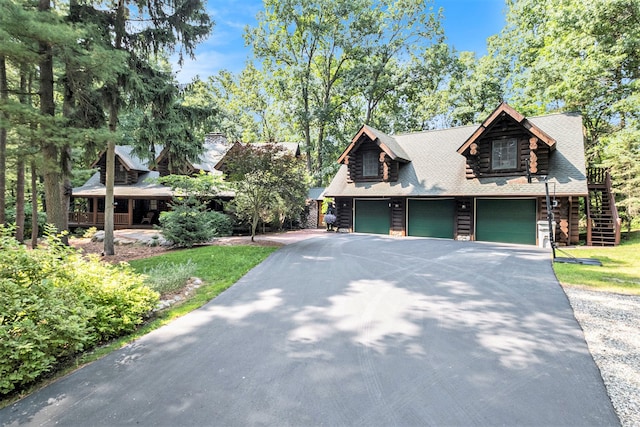 log home featuring a garage