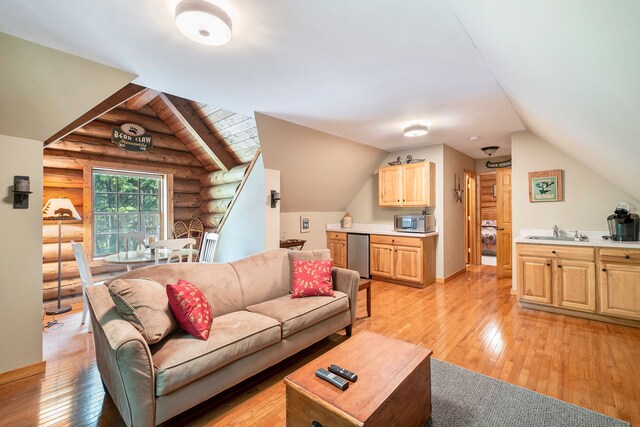 11245 Guyn Dr, Brighton, MI 48114 - living room featuring rustic walls, light wood-style flooring, and lofted ceiling