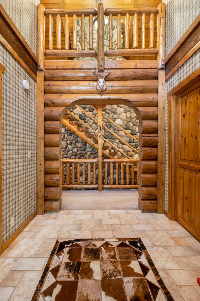 11245 Guyn Dr, Brighton, MI 48114 - wine area featuring stone tile floors, rustic walls, and a high ceiling
