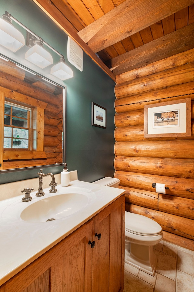 bathroom with log walls, wooden ceiling, tile patterned flooring, toilet, and vanity