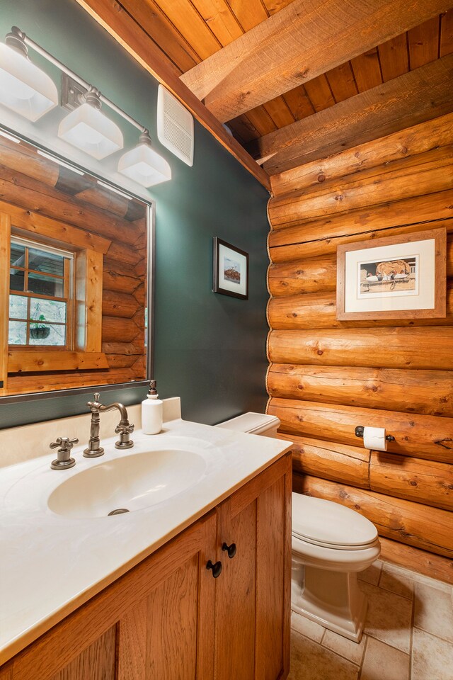 11245 Guyn Dr, Brighton, MI 48114 - bathroom featuring rustic walls, vanity, toilet, and wooden ceiling with exposed beams