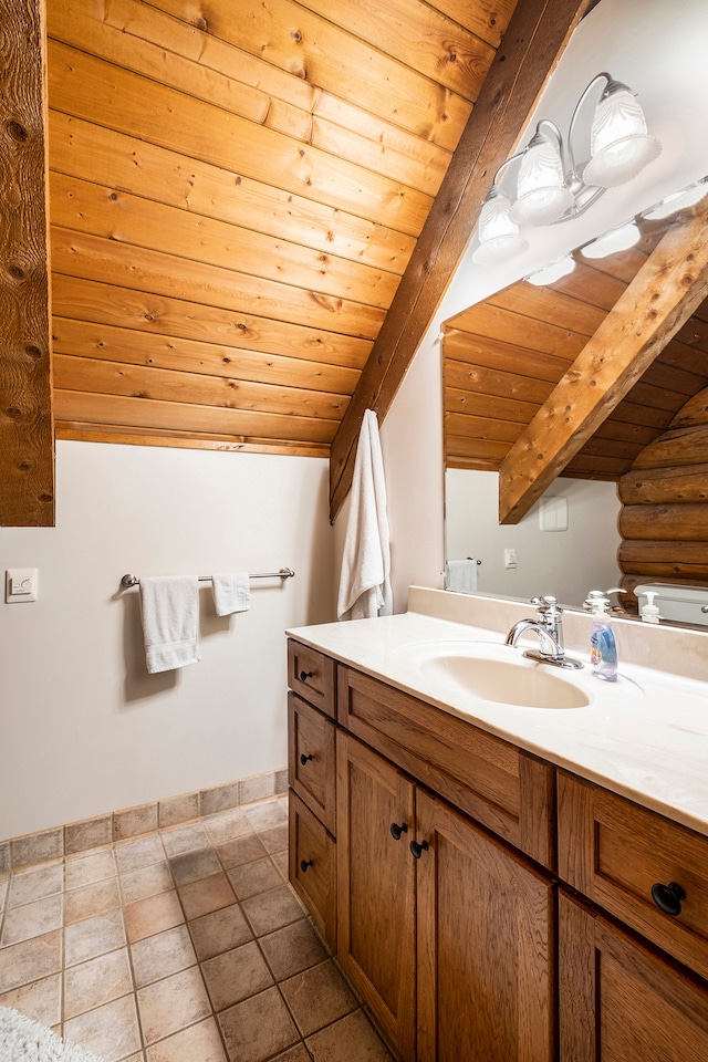 bathroom with tile patterned floors, vaulted ceiling with beams, vanity, and wooden ceiling