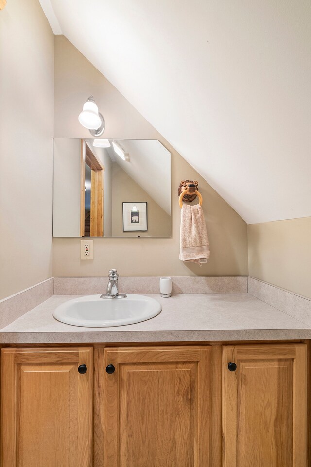 11245 Guyn Dr, Brighton, MI 48114 - bathroom featuring vaulted ceiling and vanity