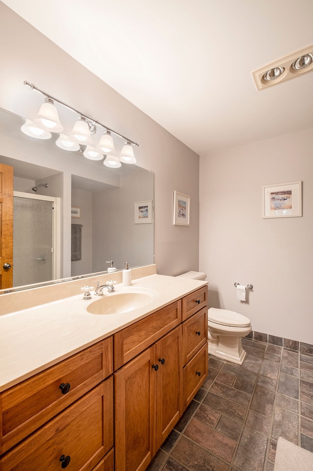 bathroom with vanity, toilet, and walk in shower