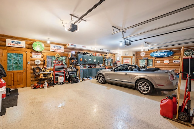 garage with a workshop area and a garage door opener