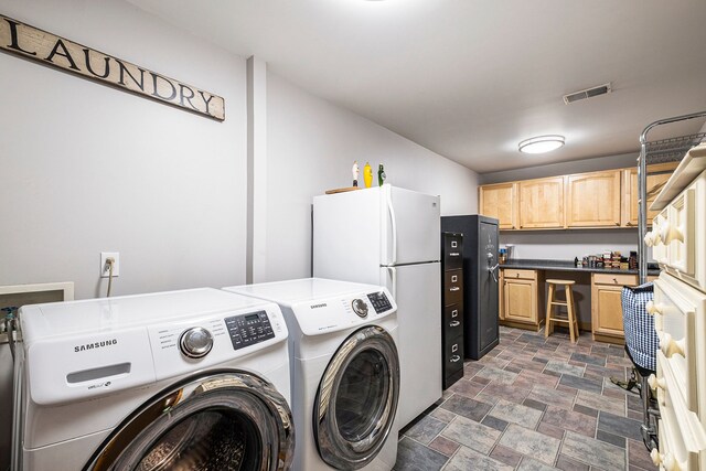 11245 Guyn Dr, Brighton, MI 48114 - laundry area with stone finish flooring and independent washer and dryer