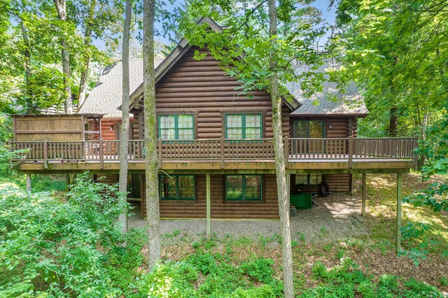 11245 Guyn Dr, Brighton, MI 48114 - rear view of house with a deck and log siding