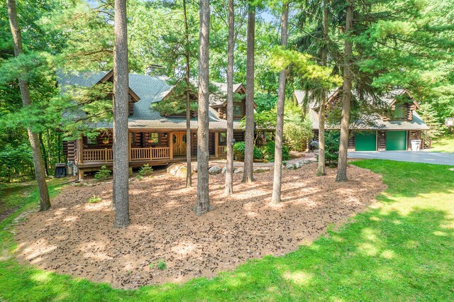 11245 Guyn Dr, Brighton, MI 48114 - view of front of property featuring log exterior, driveway, a shingled roof, and a front yard