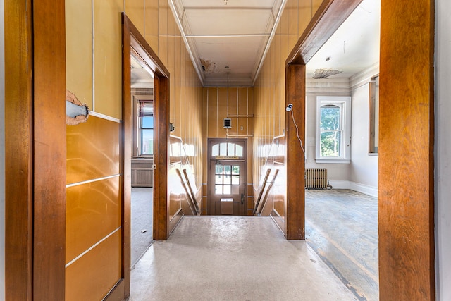 corridor with radiator heating unit and concrete flooring