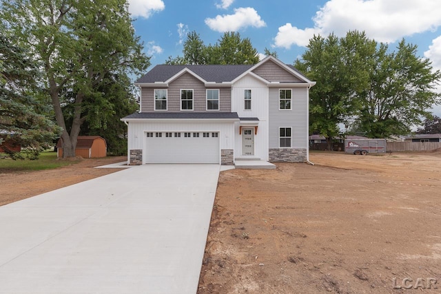 view of front of property featuring a garage and a storage unit