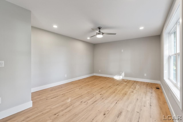 spare room featuring ceiling fan and light hardwood / wood-style flooring