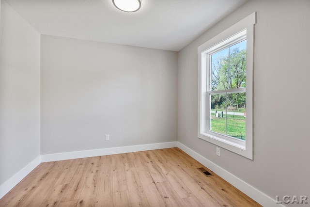 spare room with light hardwood / wood-style flooring