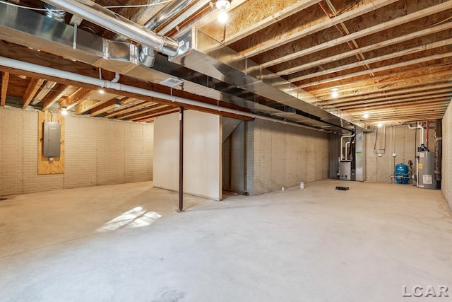 basement with electric panel, brick wall, and gas water heater