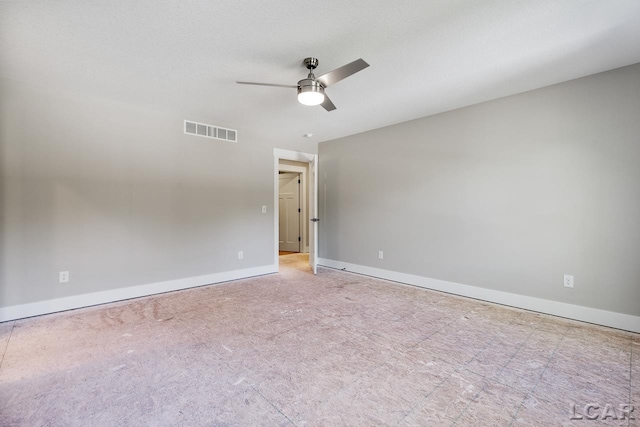 empty room with a textured ceiling and ceiling fan