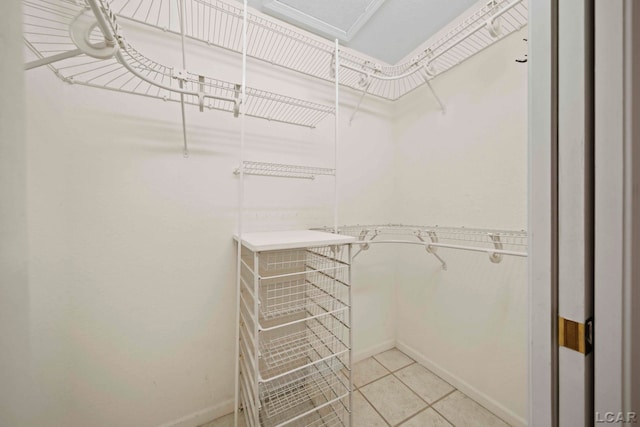 walk in closet featuring light tile patterned flooring