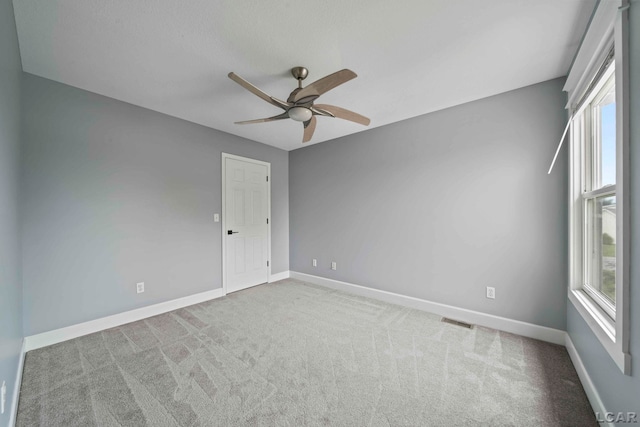 unfurnished room with light carpet and ceiling fan