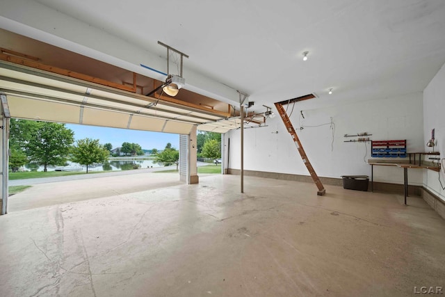 garage with a water view and a garage door opener