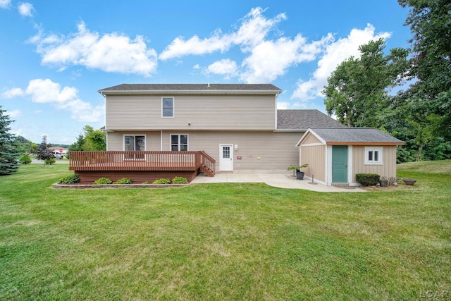 back of house with an outbuilding, a deck, a patio area, and a lawn