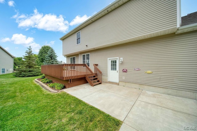 back of house with a lawn, a patio area, and a wooden deck