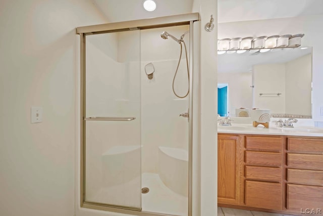 bathroom with vanity and a shower with door