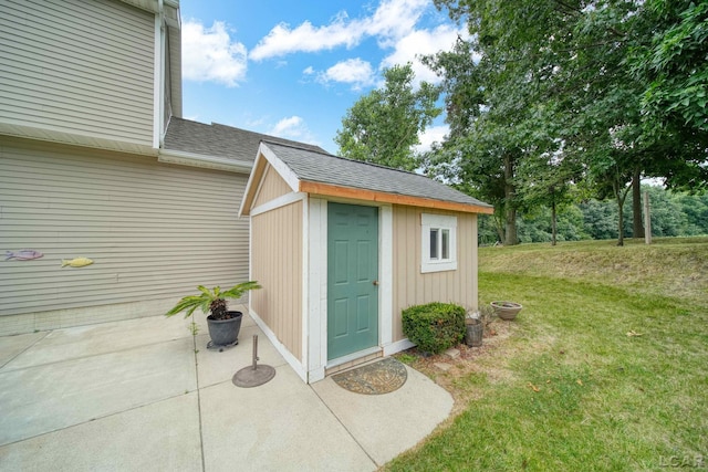 view of outbuilding with a yard